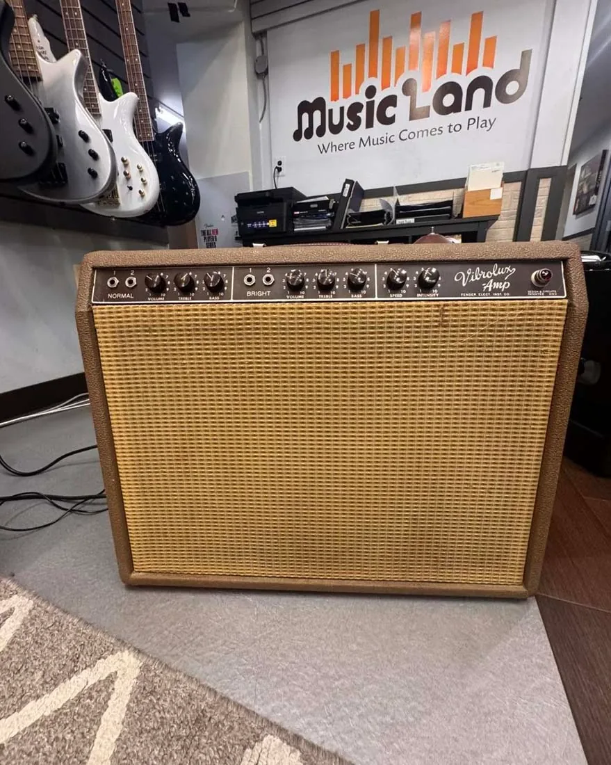 Music Land employee reviewing a used instrument for consignment in Bel Air Maryland
